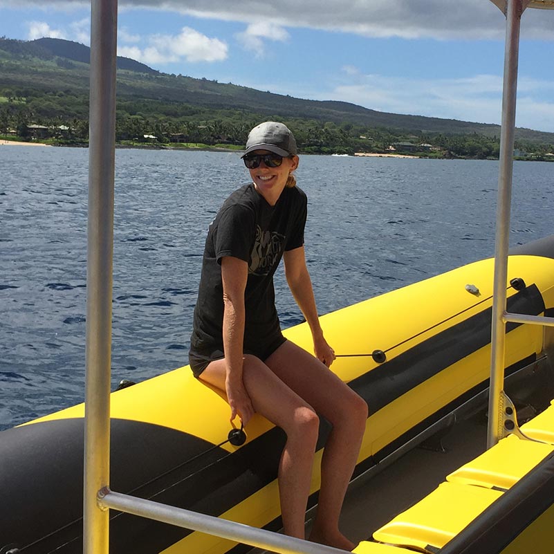 Brittany Thompson sitting on the edge of the boat
