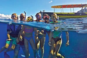 half underwater photo of happy guests in the water